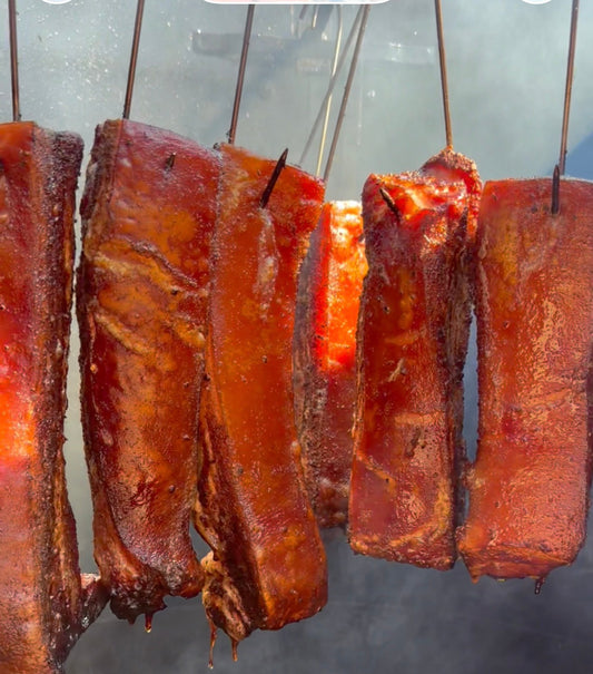 Crispy pork belly from a drum smoker served with Mojo Rojo Sauce