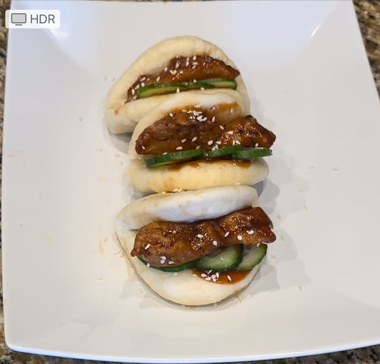 Korean fried chicken bao bun tacos with cucumber and Asian Bang Sauce