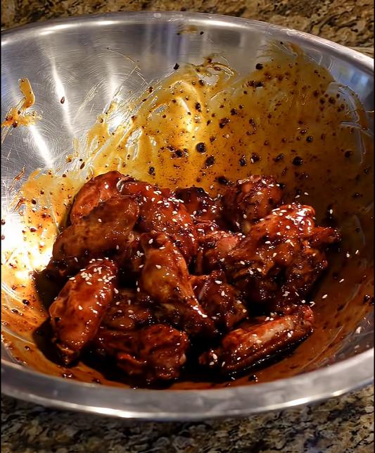 Smoked and fried Tour of Asia chicken wings coated in Asian Bang Sauce